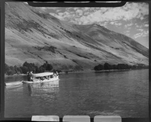Lake Ohau, Waitaki District, Canterbury Region, showing charter boat with passengers and mountains in the background