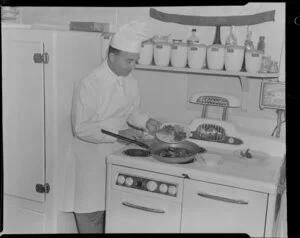 Pan American World Airways courtesy flight, showing chef preparing meals for passengers