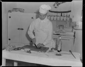 Pan American World Airways courtesy flight, showing chef preparing meals for passengers