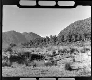 Lake Brunner, West Coast Region, showing dinghy up against river bank