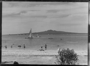 Mission Bay, Auckland, showing people on the beach and Rangitoto Island in the background