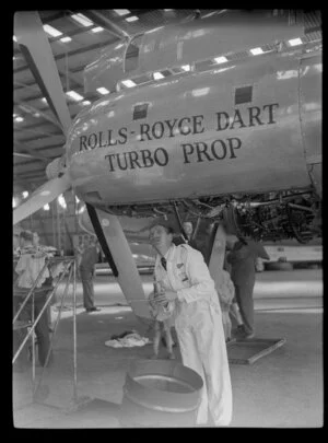 Mr S R Jones, working on a Rolls-Royce Dart Turbo prop aircraft engine during the 1953 London-Christchurch Air Race, Harewood Airport, Christchurch