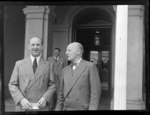 Aviation representatives during the 1953 London-Christchurch Air Race, Christchurch, standing outside a building