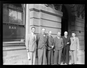 Aviation representatives during the 1953 London-Christchurch Air Race, Christchurch, outside a private bar