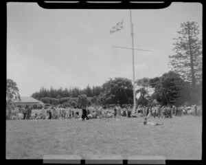 Waitangi Treaty grounds scene, including flag pole, Treaty House and people enjoying the ceremony for Queen Elizabeth, Bay of Islands