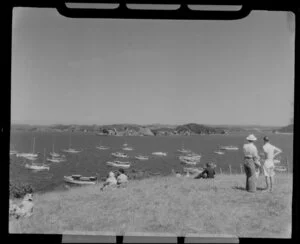 Waitangi Treaty grounds scene, including people relaxing and enjoying the view of boats in the bay, Bay of Islands