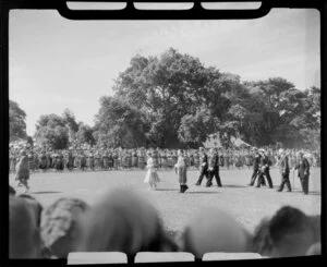 Waitangi Treaty grounds scene, including Queen Elizabeth and Prince Phillip, Naval officers, Government officials, Maori group performing, Bay of Islands