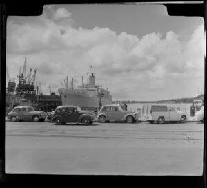 Ship Oronsay berthed at Auckland waterfront, including cars parked on wharf