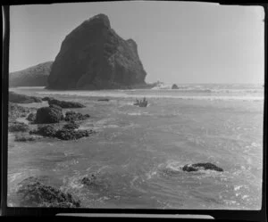 Piha, Auckland, showing people in a dinghy