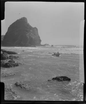 Piha, Auckland, showing people in a dinghy