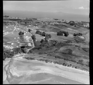Stanmore Bay, Whangaparaoa Peninsula, Auckland Region, showing houses and beach