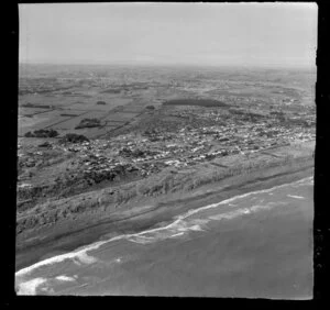 Castlecliff, Wanganui, coastal view over beach and houses, with farmland and city beyond