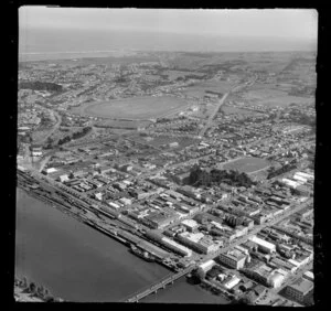 View of Victoria Avenue and Cooks Gardens, Wanganui, with railyards and wharf, commercial and residential buildings, cricket grounds and racecourse beyond