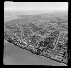 View over Gonville, Wanganui, showing commercial and residential housing, with the Wanganui River, Castlecliff and coast beyond