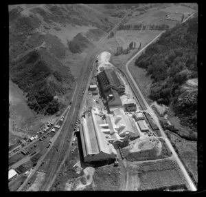 Wanganui, closeup view over Kempthorne Prosser Chemical Works between Brunswick Road and railway yard with stacked timber