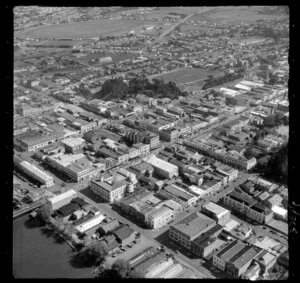 Wanganui, showing Victoria Avenue with residential and commercial buildings and Cooks Gardens with running track, racecourse beyond