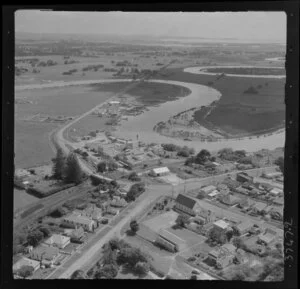 Helensville, Auckland, showing Mill Road and Commercial Road (part of State Highway 16), Puriri Street and Kowhai Street intersection, dairy factory and Kaipara River with oxbow bends