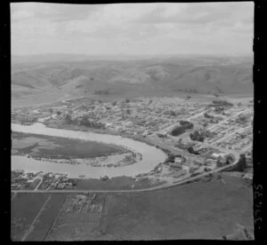 Helensville, Auckland, showing Mill Road (part of State Highway 16), Kaipara River with oxbow bends and dairy factory