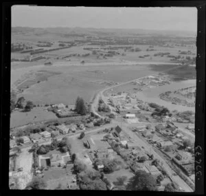 Helensville, Auckland, showing Kowhai Street and Puriri Street intersection, tennis courts, dairy factory and Kaipara River with Mill Road