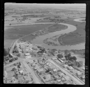 Helensville, Auckland, showing Mill Road and Commercial Road (part of State Highway 16), dairy factory and housing, Kaipara River with oxbow bends