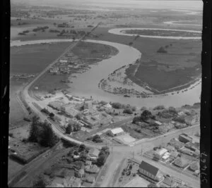 Helensville, Auckland, showing Mill Road and Commercial Road (part of State Highway 16), dairy factory with rail line, Kaipara River with oxbow bends