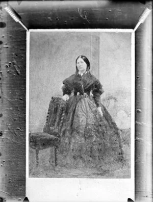 Unidentified woman, wearing a gingham dress with an embroidered bodice