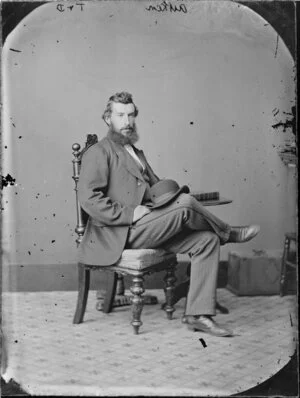 Seated portrait of a man in a suit, probably Mr Aitken; he has a bowler hat on his knee - Photograph taken by Thompson & Daley