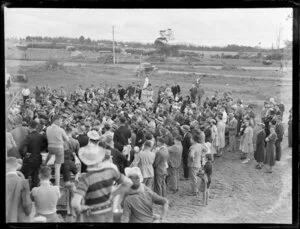 Royal New Zealand Air Force base, Whenuapai, crowd listening to speech, with earthmoving equipment
