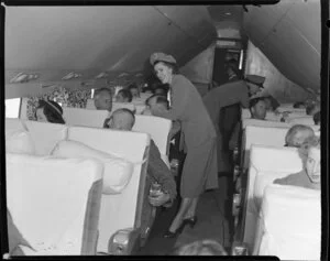 Hostess and passengers on British Commonwealth Pacific Airlines flight