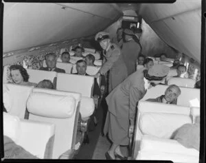 Crew on British Commonwealth Pacific Airlines flight with passengers