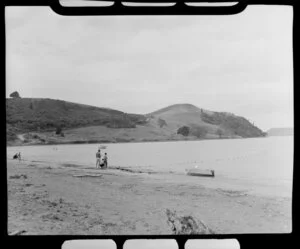 People with a large net off the beach, Brophy's Beach, Whitianga