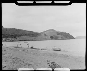 People with a large net off the shore, Brophy's Beach, Whitianga