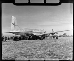 Douglas DC-6 aircraft on airfield, surrounded by spectators, dedication of Harewood Airport, Christchurch