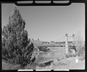 Suspension bridge, Lake Tekapo, with Church of the Good Shepherd in distance