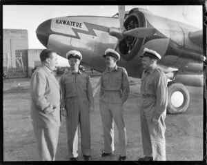 Pilots with unidentified person in front of New Zealand National Airways Corporation (N A C) Lodestar ZK-ANA aircraft named 'Kawatere', location unidentified