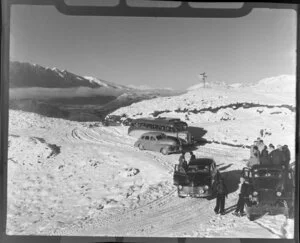 People in truck, cars and bus arriving at Coronet Peak, Otago