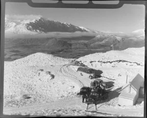 View over newly arrived people and vehicles to distant mountains, Coronet Peak, Otago