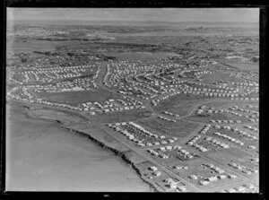 View of new housing development Glen Innes, Auckland City, showing Dunkirk Road by estuary harbour and Tripoli Road through housing estate with school, to Panmure with bridge and Panmure Basin