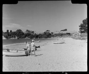 Stanmore Bay, Whangaparaoa Peninsula, showing people and dinghies on beach