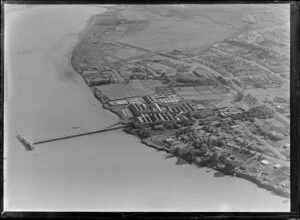 View over the New Zealand Refrigerating Company, Imlay Freezing Works Imlay Place, Wanganui, with stock pens and yards, showing Heads Road, Balgownie Avenue surrounded by residential housing, located beside the Wanganui River with wharf for loading ships