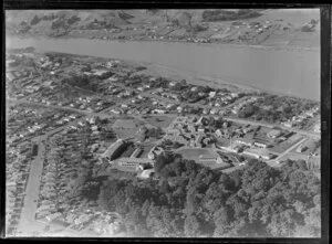 Close-up view over Wanganui Public Hospital, surrounded by residential housing with Tawa Street and Koromiko Road and Heads Road, looking southeast to the Wanganui River and Putiki settlement beyond