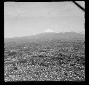 View to Mount Taranaki and the Pouakai Range over New Plymouth Township, Taranaki District, with outer suburbs residential housing and farmland beyond