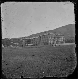 Government Buildings, Lambton Quay, Wellington, showing area of reclamation in foreground and Government House at right