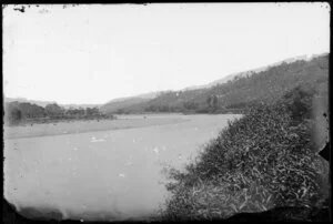 River bend, showing hills cleared for building, probably Hutt Valley