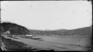 Oriental bay, Wellington, showing a boatshed and houses, looking across harbour to city and Thorndon