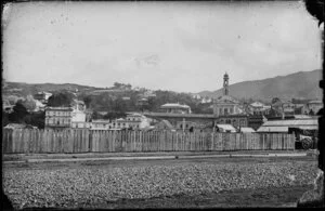 View from Thorndon Quay, Wellington, showing buildings on Lambton Quay including Queen's Hotel and Casey & McDonald miliners and drapers, and The Terrace, including St-Andrew's-on-the-Terrace Presbyterian church