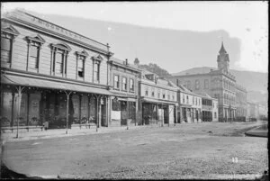 Buildings on Lambton Quay, Wellington, including the premises of J McDowell & Company, with the Wellington Literary and Scientific Institute and the Wellington Working Men's Club upstairs, fruiterer WF Ross, Barrett's Hotel, the Exchange building, and South British Insurance Company of New Zealand