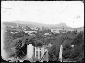 View from [Bolton Street?] cemetery of Thorndon, Wellington, showing Goverment House, Parliament Buildings with construction site alongside, St Mary's Catholic Cathedral on Hill Street, and houses