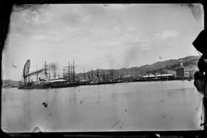 Queens Wharf, Wellington, showing ships docked at wharves and buildings on Customhouse Quay and Jervois Quay, including the Chief Post Office
