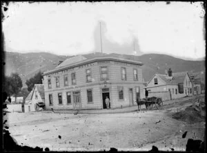 The Galatea Hotel, corner of Hawkestone and Molesworth streets, Thorndon, Wellington, showing houses adjacent and unidentified persons on street, including man in horse-drawn cart [bottle delivery?]
